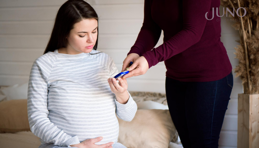 A pregnant woman checking her blood glucose level to monitor gestational diabetes.