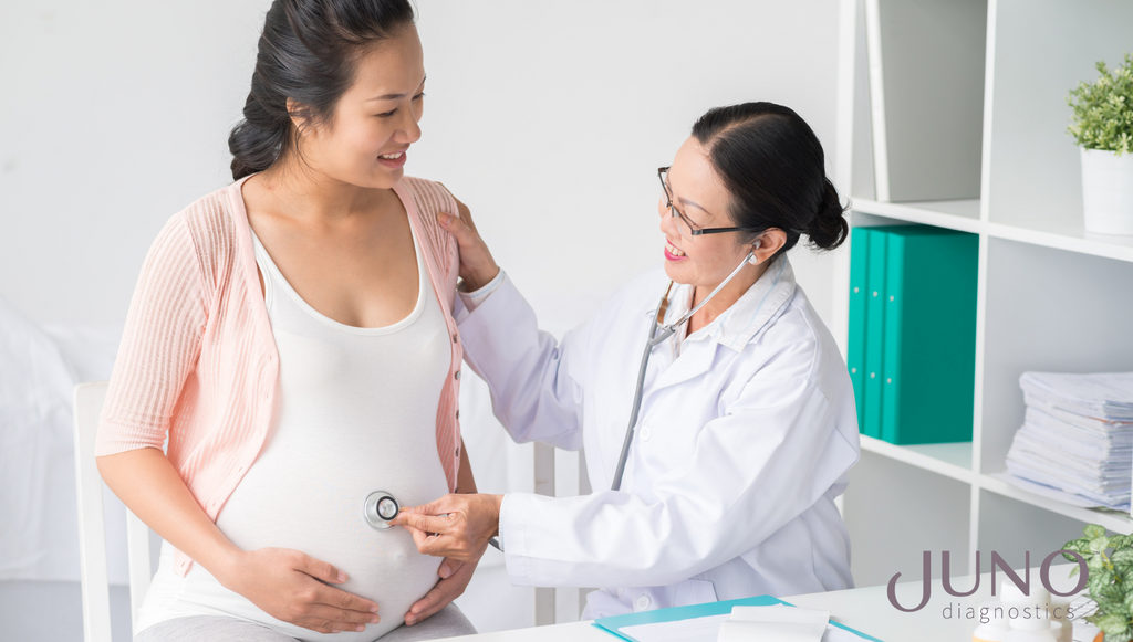 An Asian woman is meeting with her obstetrician to discuss her NIPS results